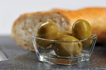 olives, baguette and olive oil closeup
