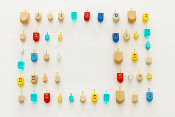 Image of jewish holiday Hanukkah with wooden dreidels colection (spinning top) over white background.