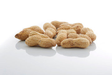 Peanuts.  unpeeled nuts isolated on white background. Peanut macro. Selective Focus