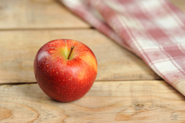 red juicy apple on wooden background