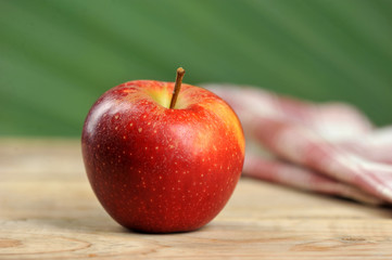 red juicy apple on wooden background