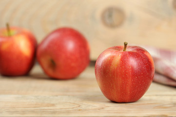 red juicy apple on wooden background