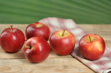 red juicy apples on wooden background