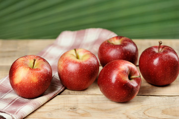 red juicy apples on wooden background