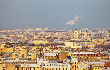 Fototapeta na wymiar St. Petersburg. Top view of the roofs of the historic center of the city and the bell tower of the Our Lady of Vladimir Church on a frosty winter day