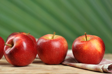 red juicy apples on wooden background