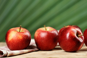 red juicy apples on wooden background