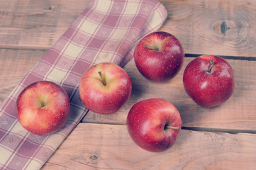 red juicy apples on wooden background