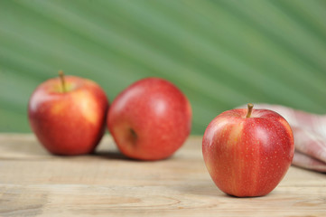 red juicy apples on wooden background