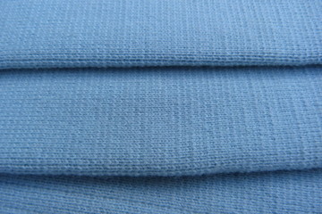 blue knitted fabric closeup background wool acrylic canvas material for clothing