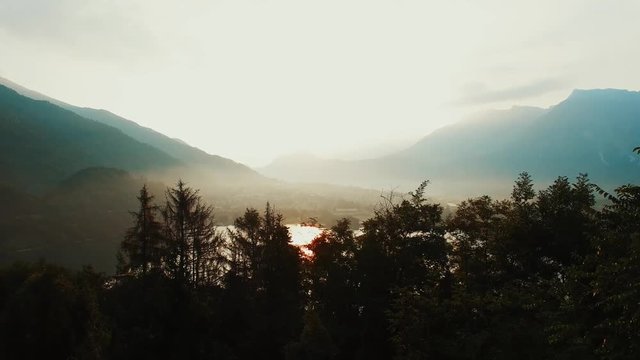 Lake sunset view. magic hour. golden dusk sky. aerial view. Levico, Italy.