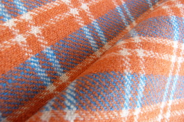 checkered wool fabric close up scottish cage drape orange white geometric pattern