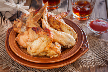 Baked chicken wings on a wooden table, horizontal