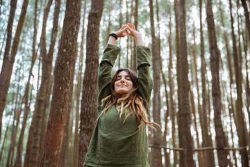 young woman hiker relaxing in the woods