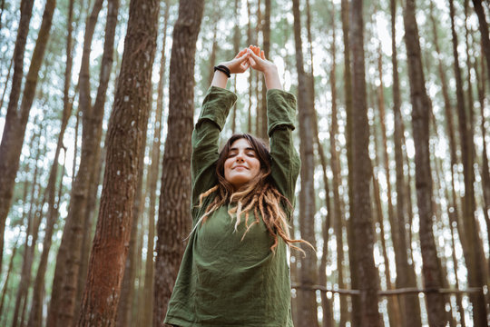 young woman hiker relaxing in the woods