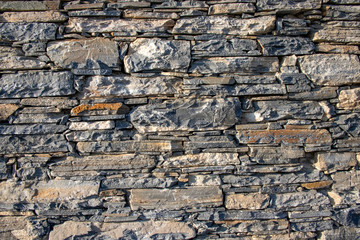 A wall of natural stones of various thickness. Background. Texture. Greece