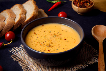 tomato soup in a gray bowl on a dark background