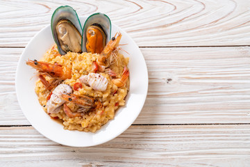 risotto with seafoods (shrimps, mussels, octopus, clams) and tomatoes