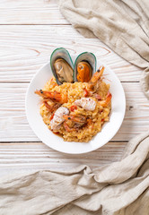 risotto with seafoods (shrimps, mussels, octopus, clams) and tomatoes