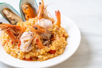 risotto with seafoods (shrimps, mussels, octopus, clams) and tomatoes