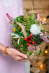 flower arrangement in hands of florist at the stage of completion