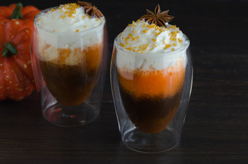 Hot pumpkin spice drink with whipped cream decorated with anise star and gold sugar. Perfect beverage for crisp autumn days and ultimate coziness