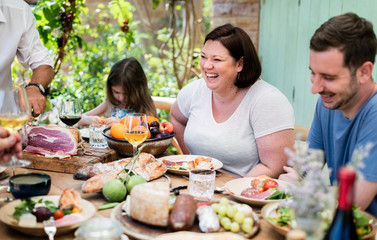 Big family having dinner at the veranda