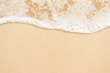Fototapeta na wymiar Soft ocean wave on sandy beach background
