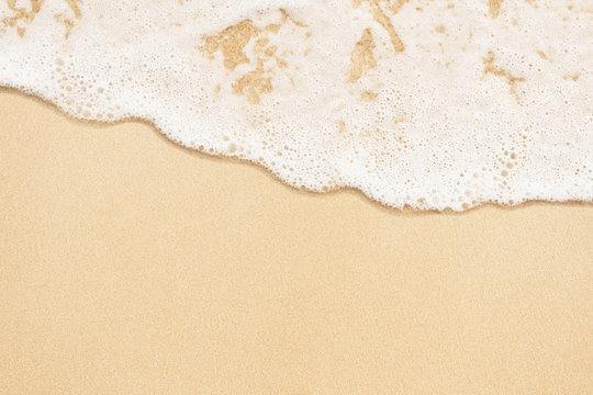 Sea foamy wave on the sand