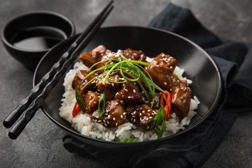 sweet sticky pork served with boiled rice, selective focus