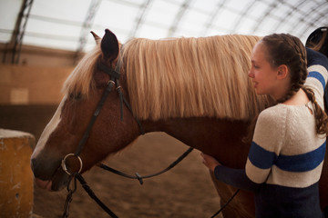 Obraz premium Horse and teen girl - best friends. Learning equestrian