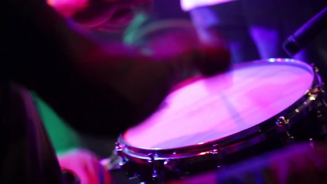 Close up of drummer playing live on stage with a band