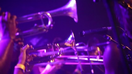 Row of trumpets on stage in purple stage lights