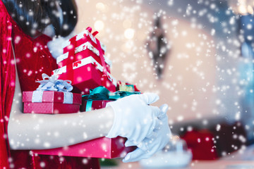 Fototapeta na wymiar Merry Christmas concept. Santa holding gift boxes with falling snow.