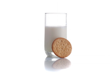 fresh milk in the glass on white background with cookies, isolated