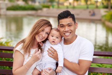 Portrait of happy young multi-ethnic family with little baby boy