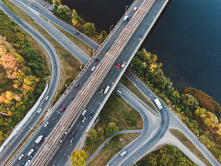 Aerial or top view from drone to road junction, freeway and bridge and car traffic in big city, urban transportation concept