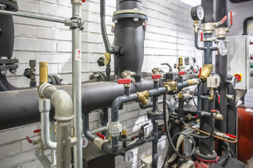 House heating system with many steel pipes, manometers and metal tubes and automated control...