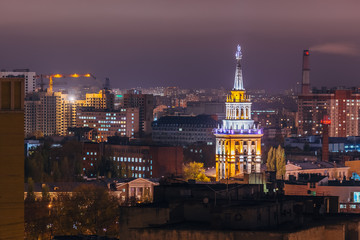 Tower in architecture Stalinist empire with star illuminated by colored lights at night. Voronezh, Russia