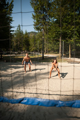 active young couple play beach volley  on hot wimmer day