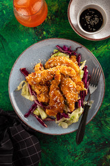 Salad with warm glazing chicken, sprinkled with sesame seeds. Chinese cuisine. Asian culture
