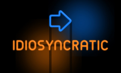 Idiosyncratic - orange glowing text with an arrow on dark background