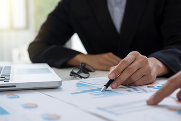 Coworking process, young business managers crew working new startup project with document graph, digital tablet and laptop computer - meeting in office