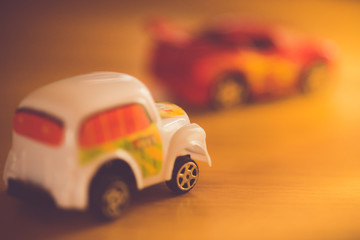 two toy cars taxi and sportcar in bright light.