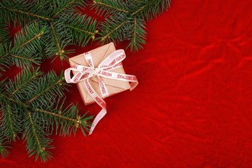 Christmas gifts with red ribbon on red background with decorations. Christmas background with copy space.