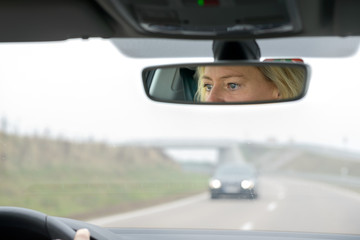 Woman driving a car on a highway