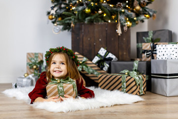 happy baby girl with christmas gifts on holidays eve