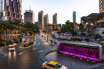 Dubai mall busy entrance with many taxis at dusk