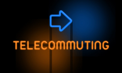 Telecommuting - orange glowing text with an arrow on dark background