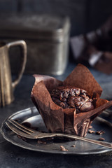 Chocolate muffin on vintage plate background. Shallow depth of field.
